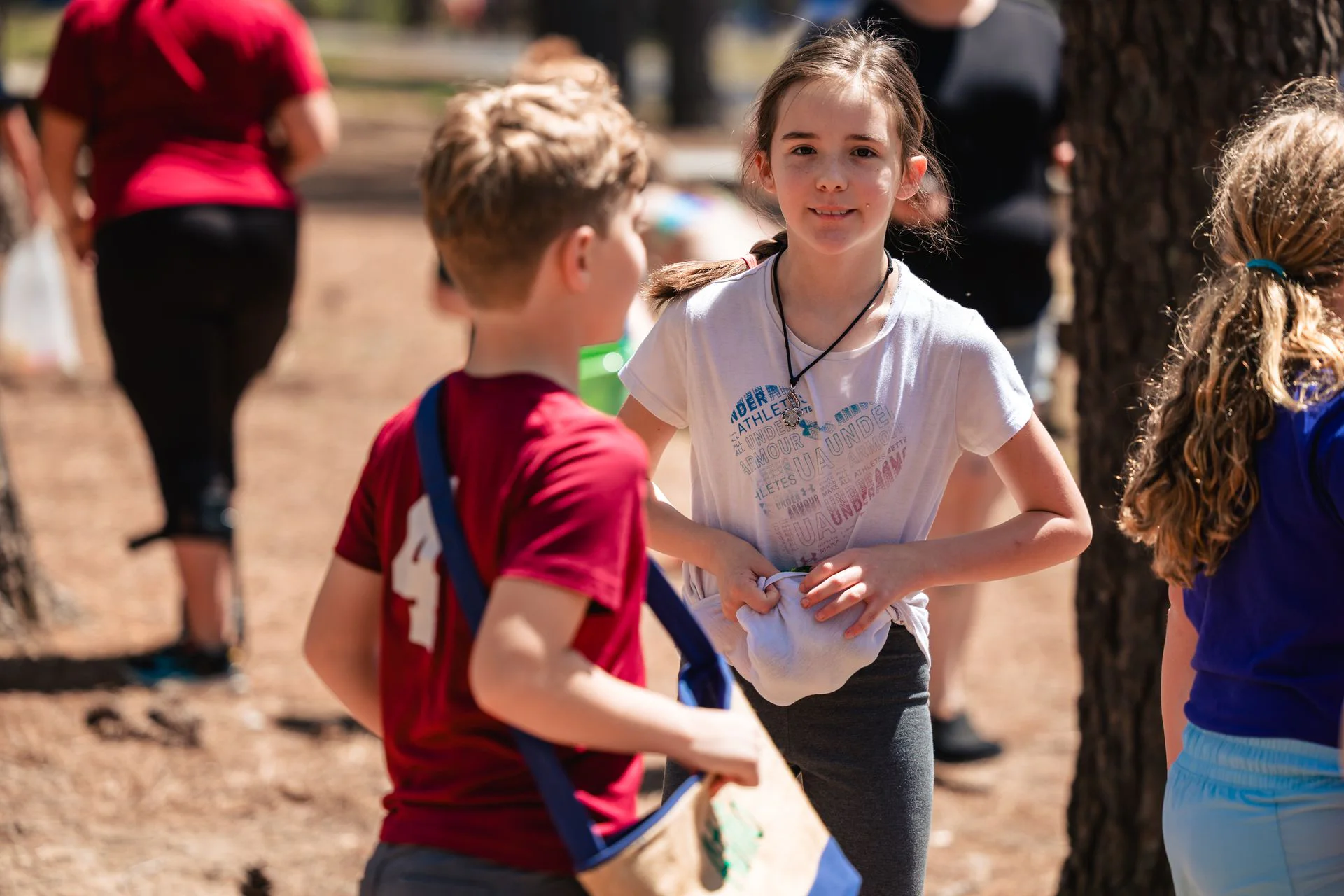 Two kids standing together in the park on Easter weekend