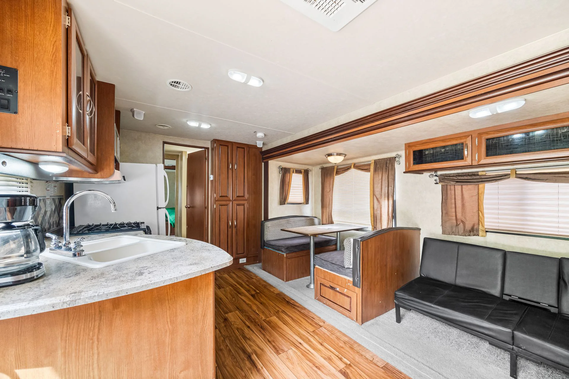 Inside a rental camper: kitchen, dining area and living room